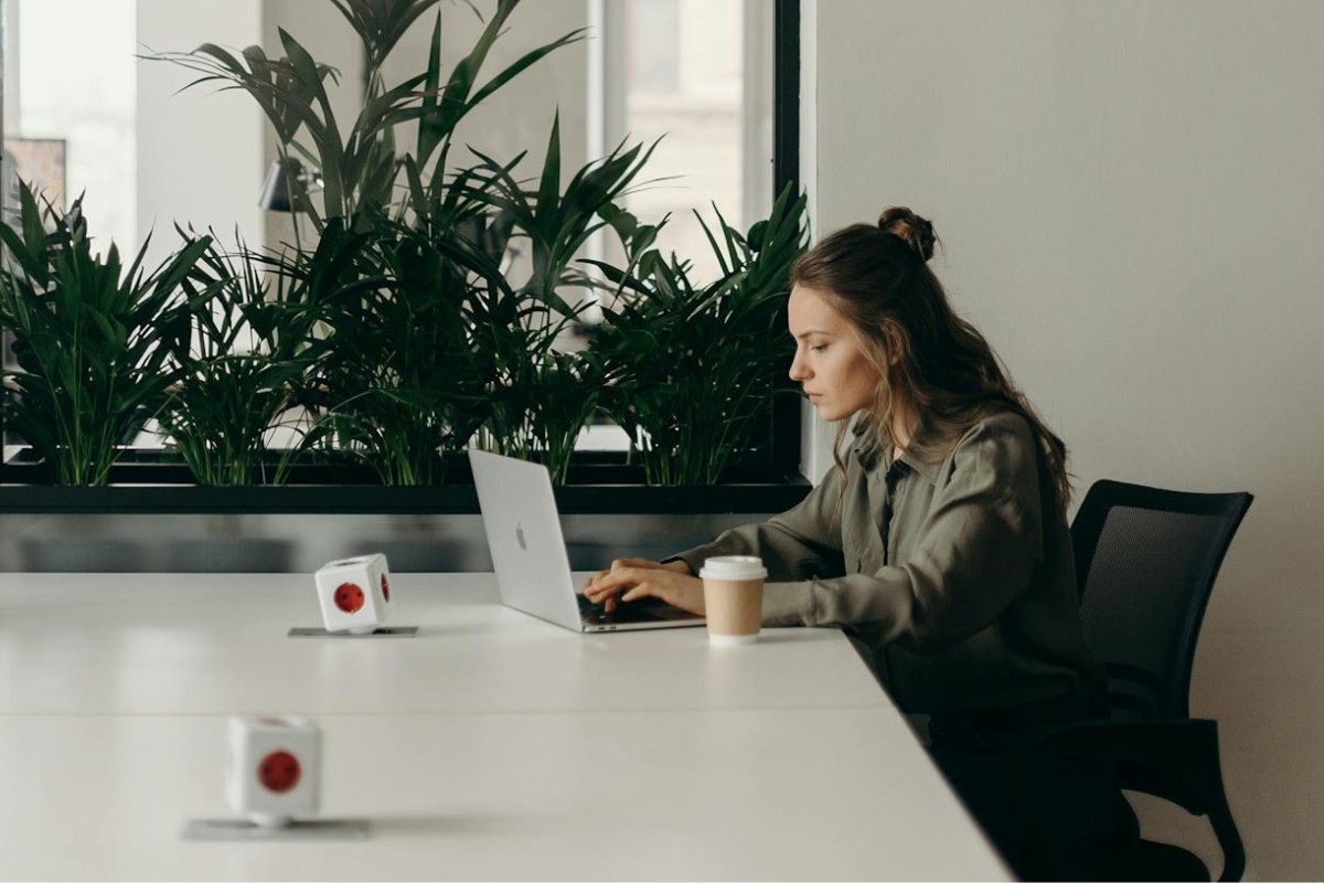 Image of woman using artificial intelligence on her laptop in the office
