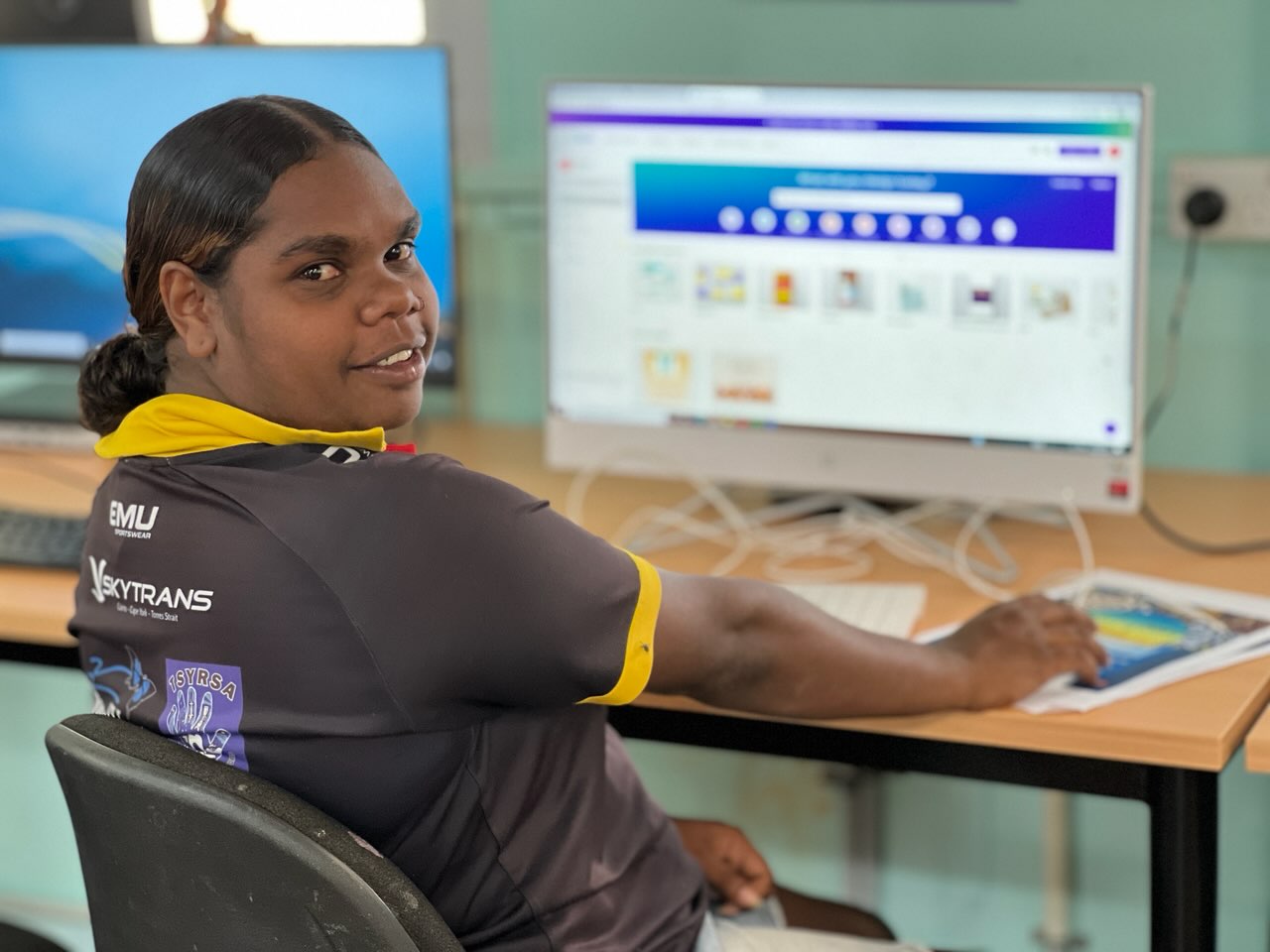 Keshiah Sykes on computer in Wujal Wujal Indigenous Knowledge Centre