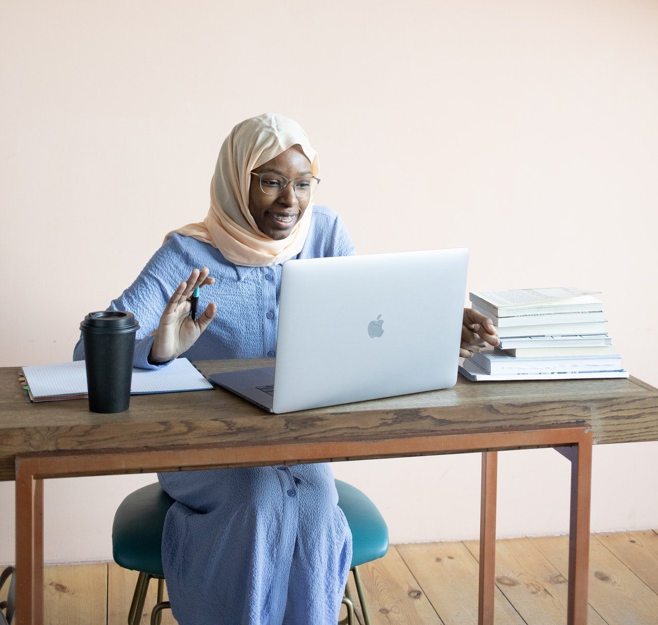 Younger woman working on a laptop outside