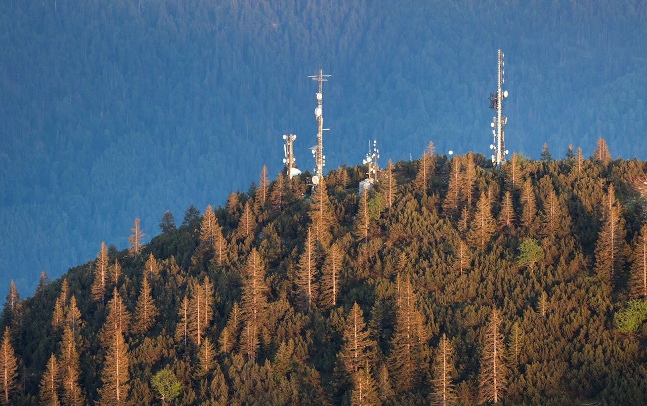 photo of mountain with telephone towers